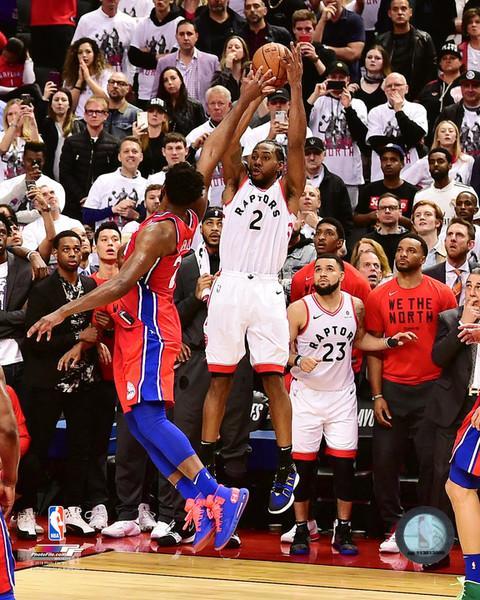 Basketball player taking a jump shot during a game